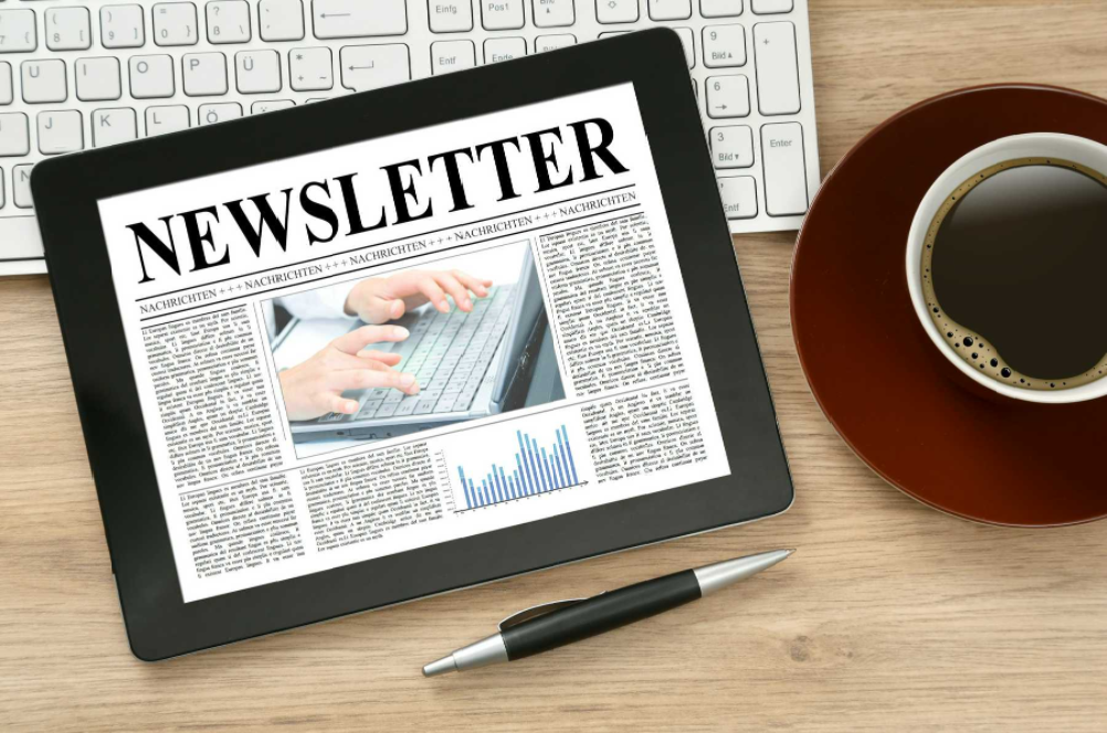 catchy church newsletter names blog - tablet on desk with pen